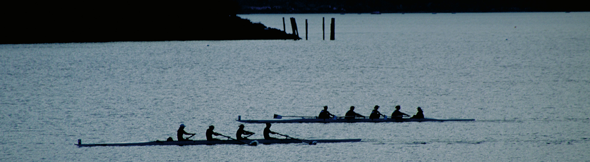 Two boats rowing at early dawn