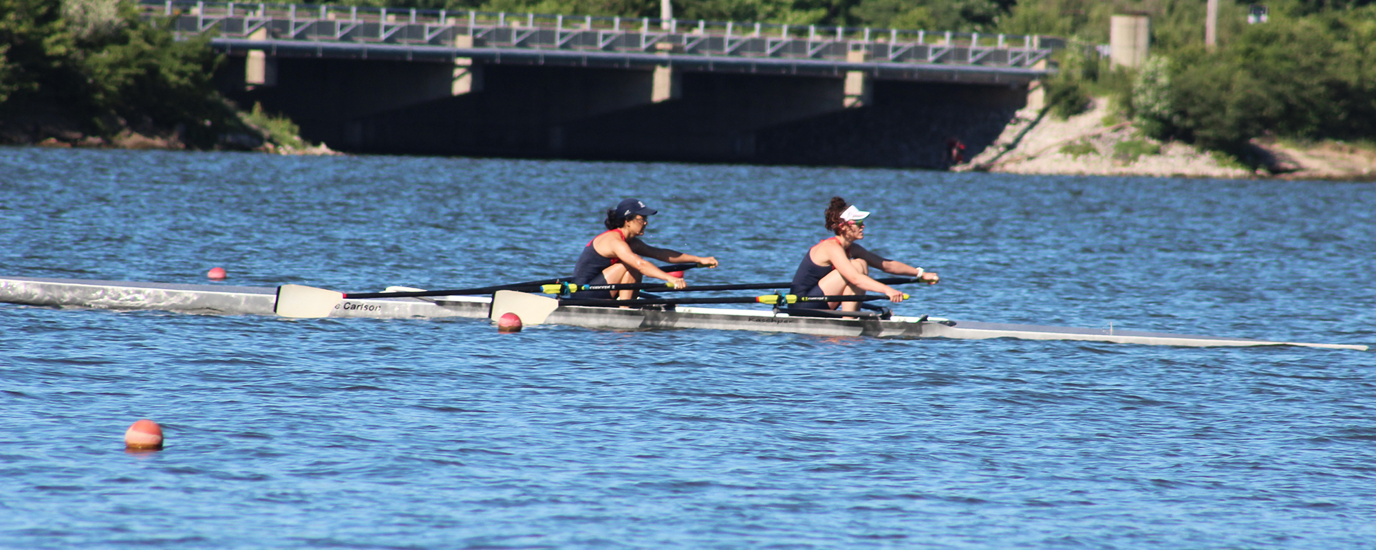 Women's pair sculling on lake in race