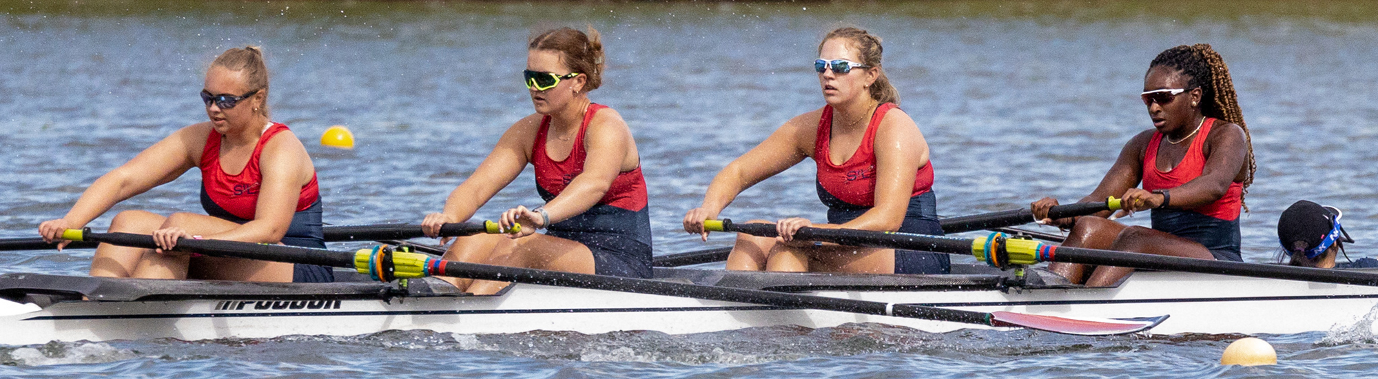 Girls varsity 4 person shell in a race